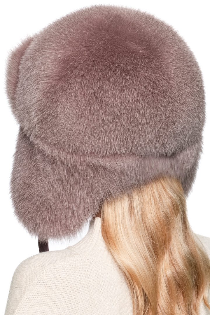 Back full view of dusty pink fox fur trapper hat, voluminous fur crown and earflaps covering sides, handmade real fur ushanka hat for winter luxury fashion.