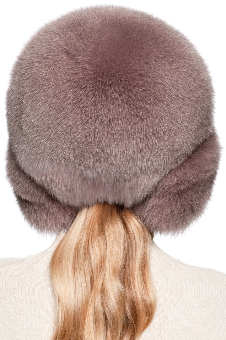 Back view of real fox fur trapper hat in dusty pink, voluminous crown and long earflaps, handmade winter ushanka hat for women, luxury après-ski headwear.
