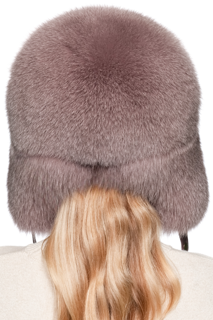 Rear close-up of dusty pink fox fur trapper hat, fluffy voluminous crown with smooth fur texture, handmade women’s winter ushanka hat in luxury style.