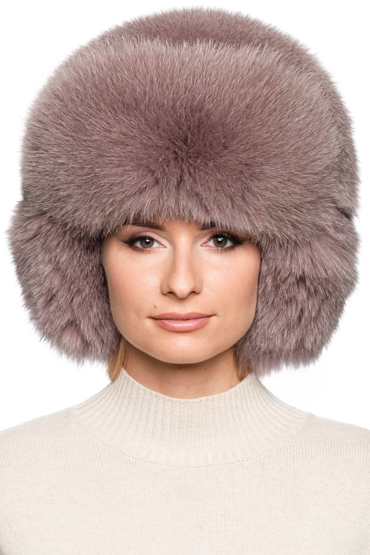 Luxury dusty pink fox fur trapper hat for women, oversized Russian ushanka style with plush earflaps and voluminous crown, warm winter fur fashion accessory.