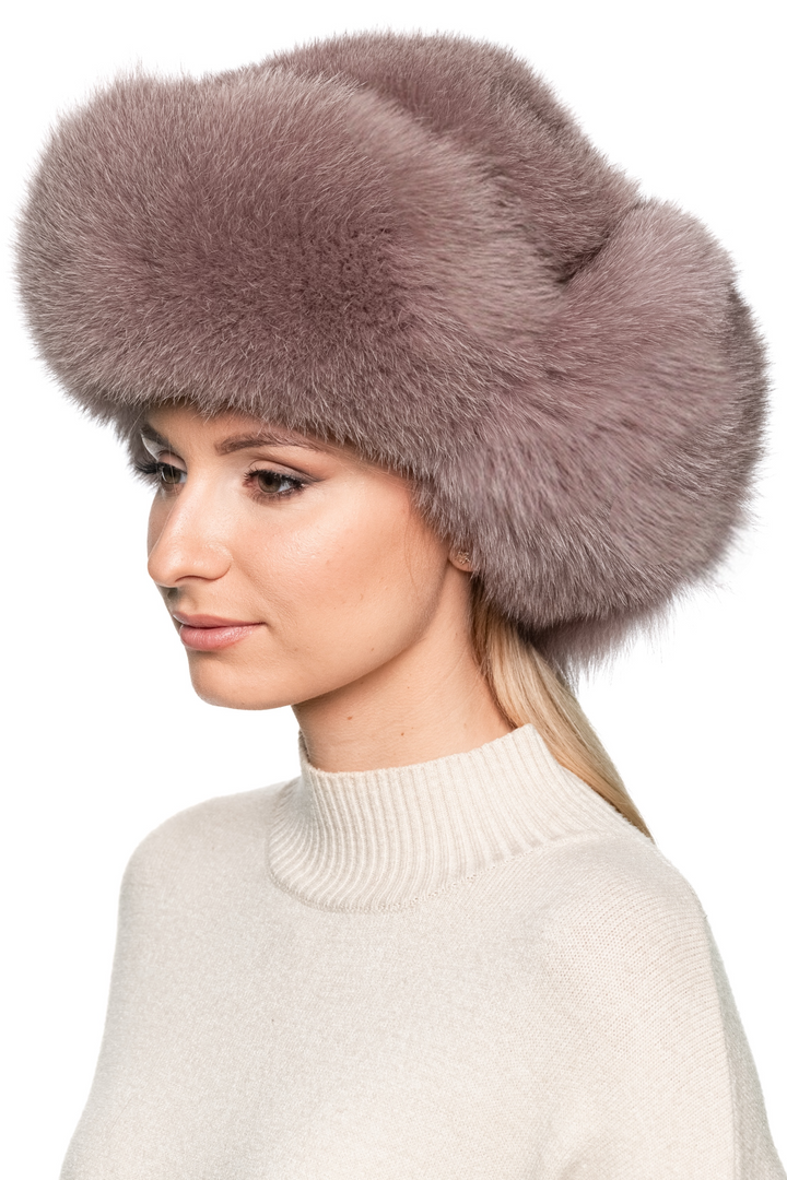 Front portrait view of dusty pink fox fur trapper hat, real fur winter ushanka with voluminous crown, warm earflaps, and luxury cold weather style.
