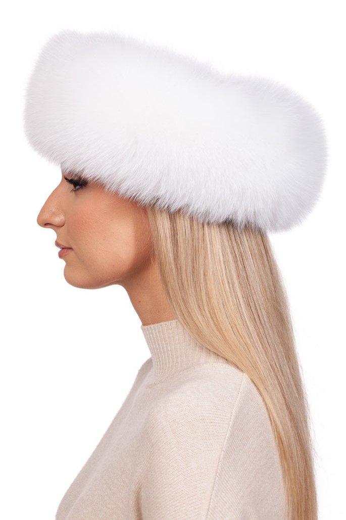 A person with long blonde hair is wearing a chic and luxurious set from FurbySD, featuring the White Fox Fur Mittens and Headband Set. The individual is posed in profile, facing left, dressed in a light beige sweater against a white backdrop that enhances the elegance of this winter ensemble.