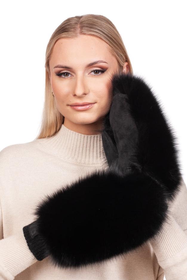 A person with long blonde hair presses a Black Fox Fur And Leather Mitten by FurbySD against their face. Dressed in a light beige turtleneck sweater, they wear subtle makeup and gaze directly at the camera with a relaxed expression.