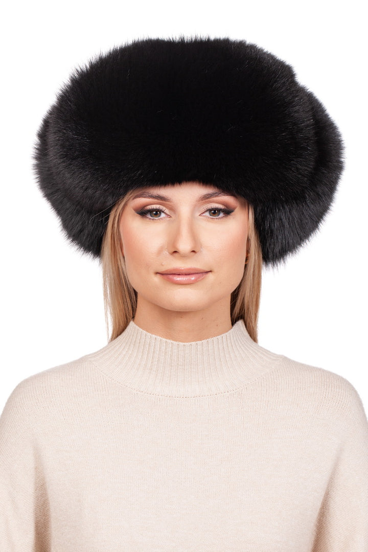 A person wearing the large Black Fox Fur Ushanka Trapper Hat by FurbySD and a light beige turtleneck sweater poses against a plain white background, showing a neutral expression.