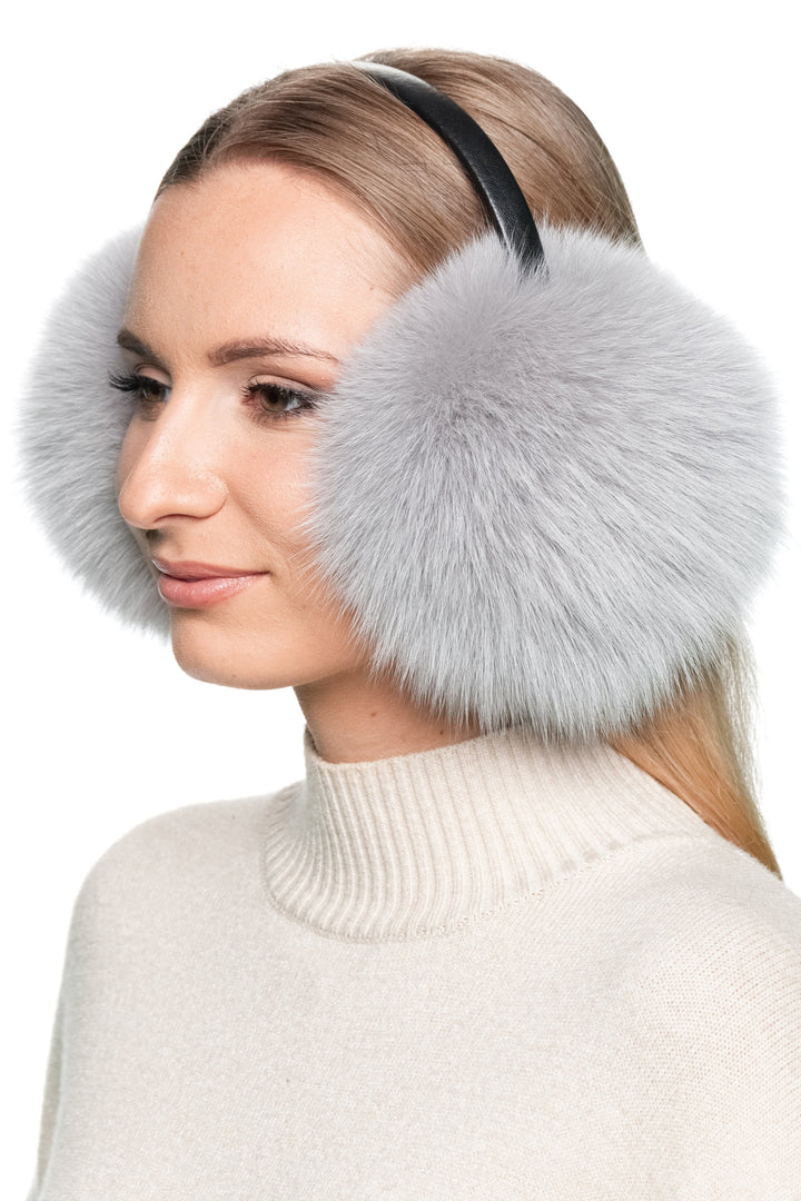 Close-up side profile of grey fox fur earmuffs with black leather headband, handmade luxury real fur winter ear warmers for stylish women.