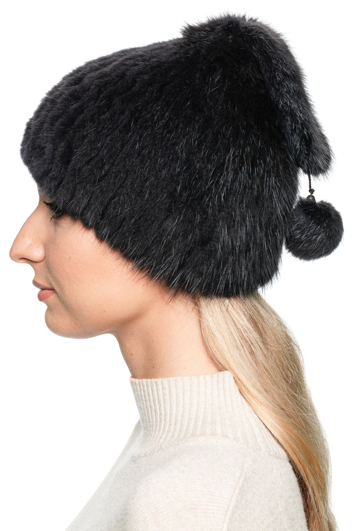 Side view of a grey muskrat fur knitted beanie hat with pom pom, handmade winter luxury hat for women.