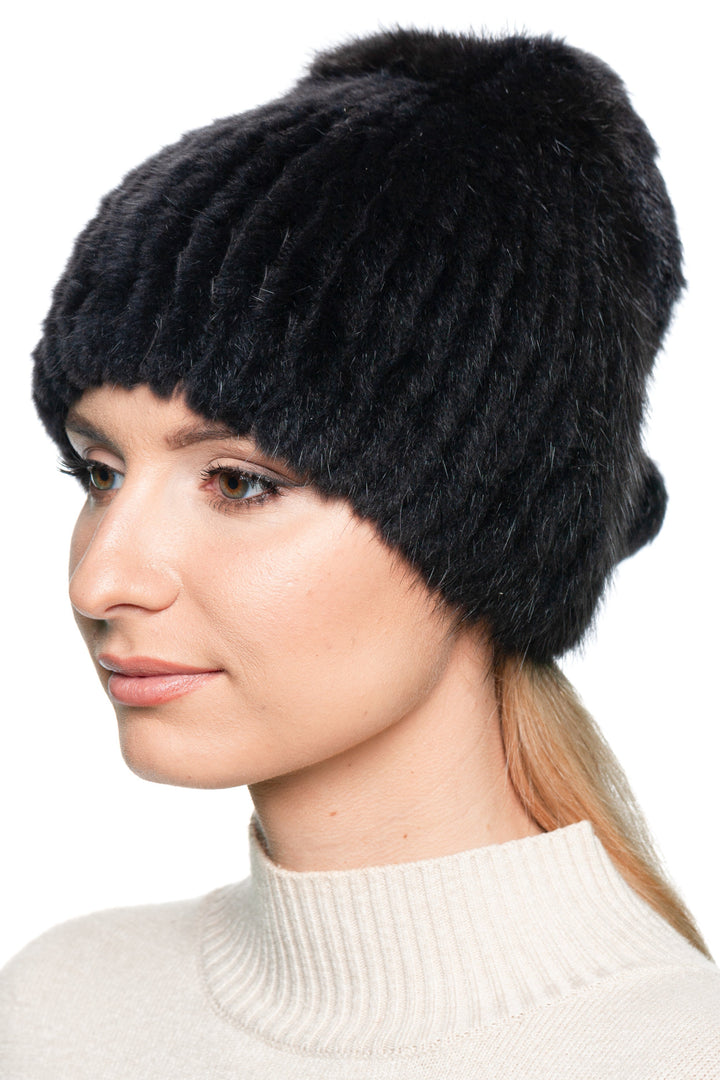 Angled side view of grey muskrat fur beanie hat with pom pom, warm handmade winter gift for her.