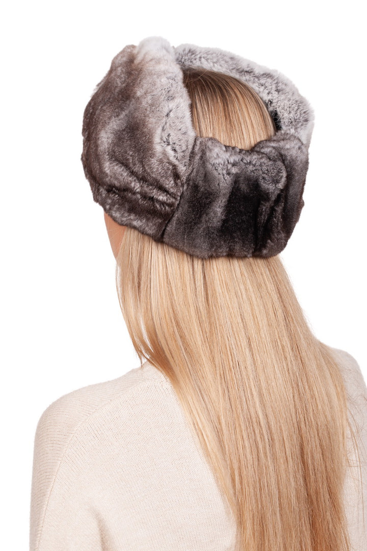 A person with long blonde hair is wearing a Grey Rex Rabbit Fur Headband by FurbySD, creating an elegant winter look. The image showcases the back view of their head and shoulders, accentuated by a cream-colored cashmere-lined sweater.