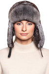 Model wearing a luxurious Grey Rex Rabbit Fur Ushanka Hat, showcasing its stylish earflaps and sleek design.