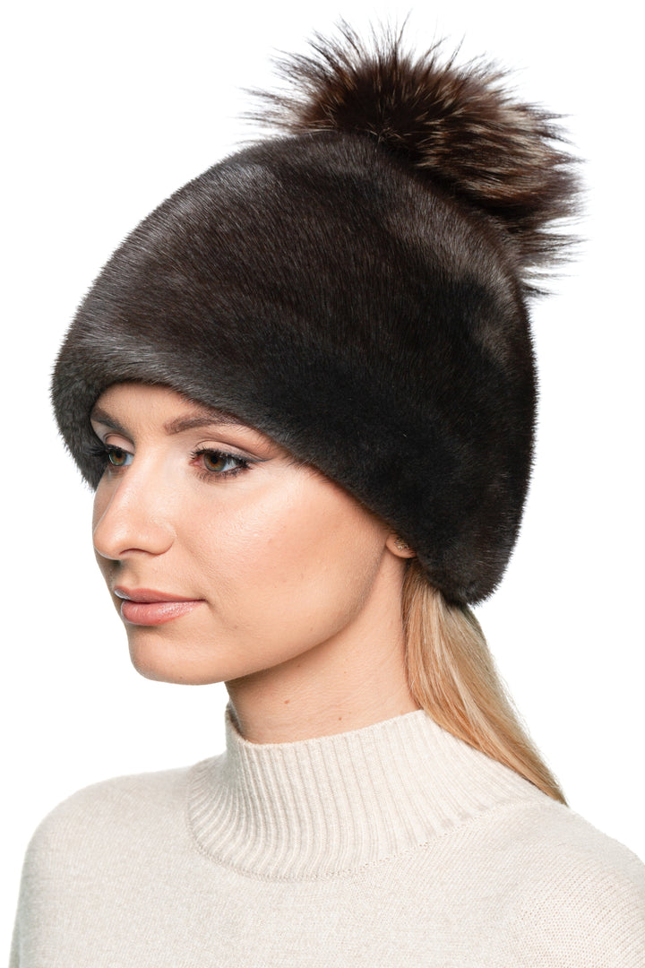 Elegant greyish brown mink fur hat with fox fur bobble, stylish handmade women’s winter headwear for cold weather.
