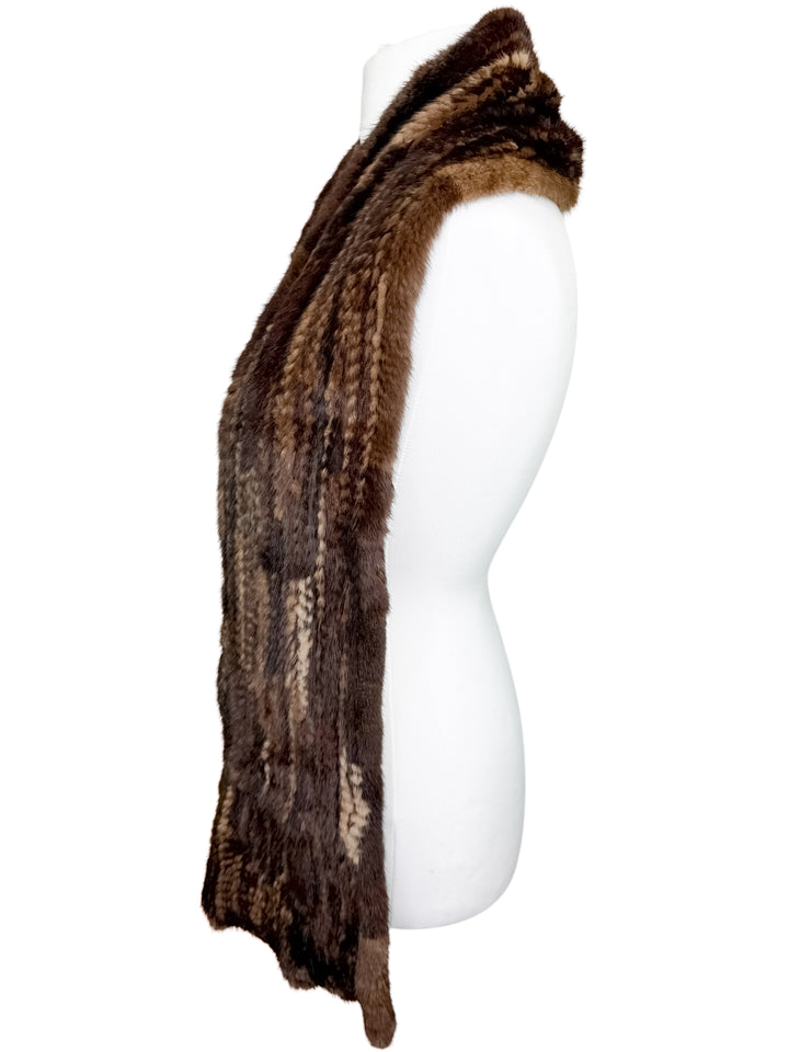 Brown knitted mink fur scarf on a mannequin against a white background