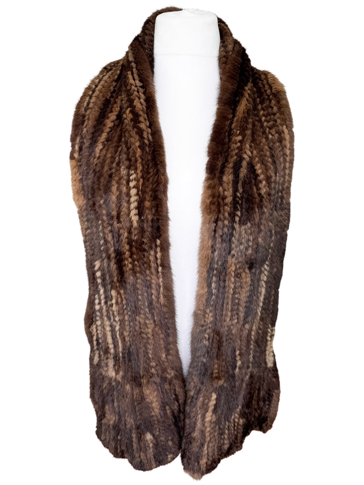 Brown mink fur knitted scarf on a mannequin against a white background