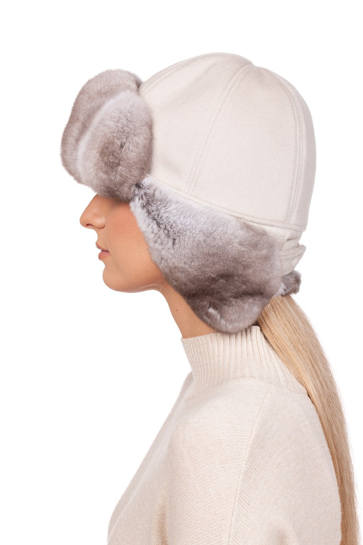 Elegant beige chinchilla fur trapper hat adorned with authentic cream cashmere for a luxurious look.