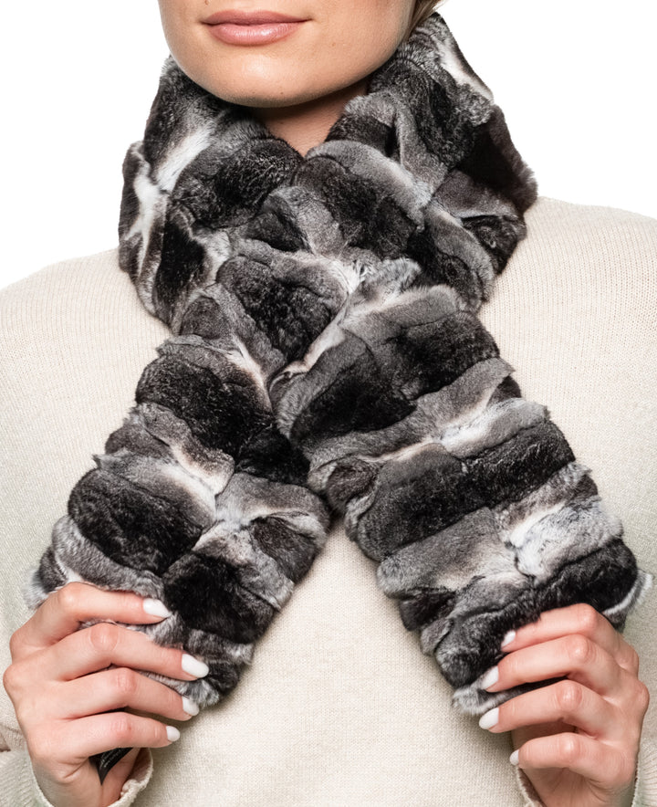 close view of woman wearing luxury chinchilla fur scarf, highlighting natural striped fur pattern, reversible design, and cozy winter elegance.