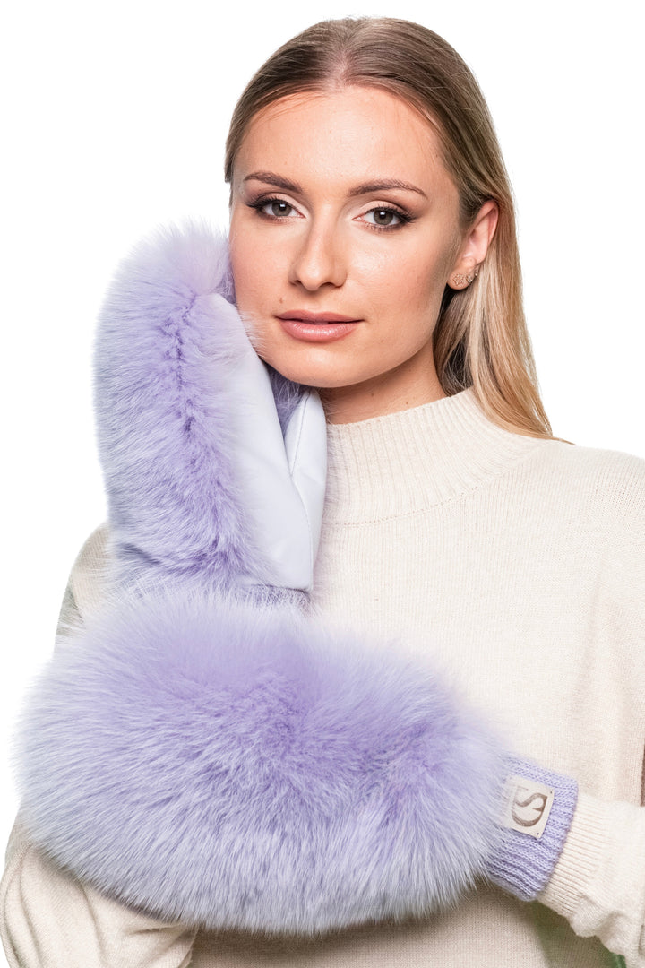 Woman wearing purple fox fur mittens with leather palms, luxury fluffy winter gloves handmade for women, perfect for skiing and cold-weather fashion.