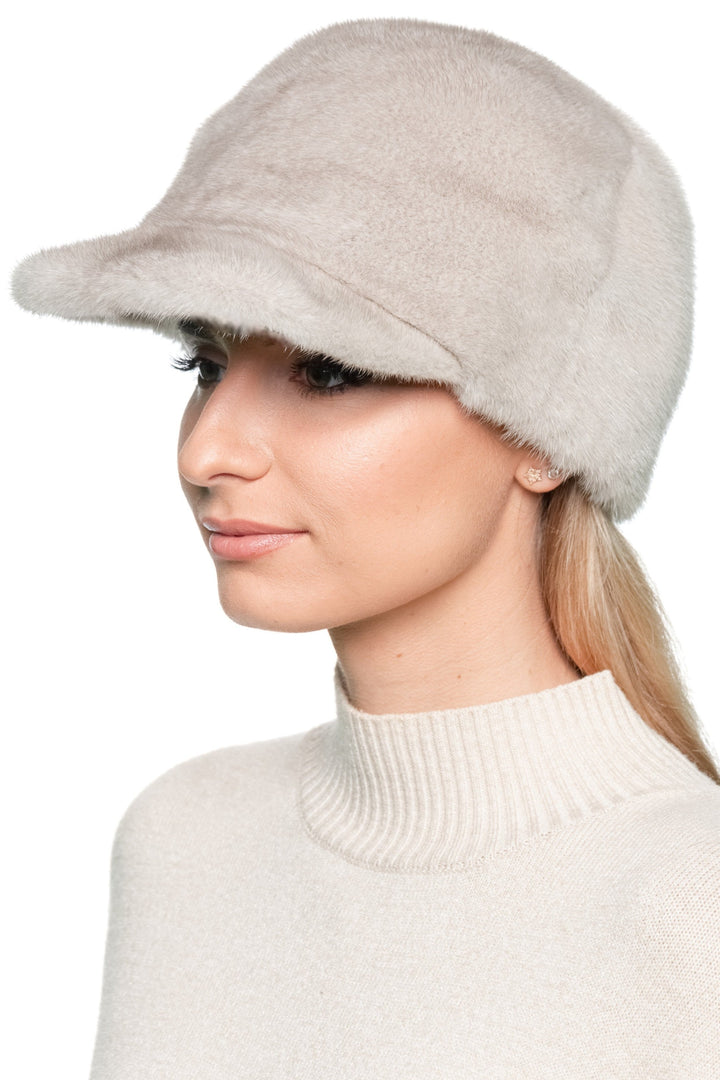 Profile view of light beige mink fur baseball hat with brim, sporty yet elegant real mink fur winter cap for women and men, adjustable size.