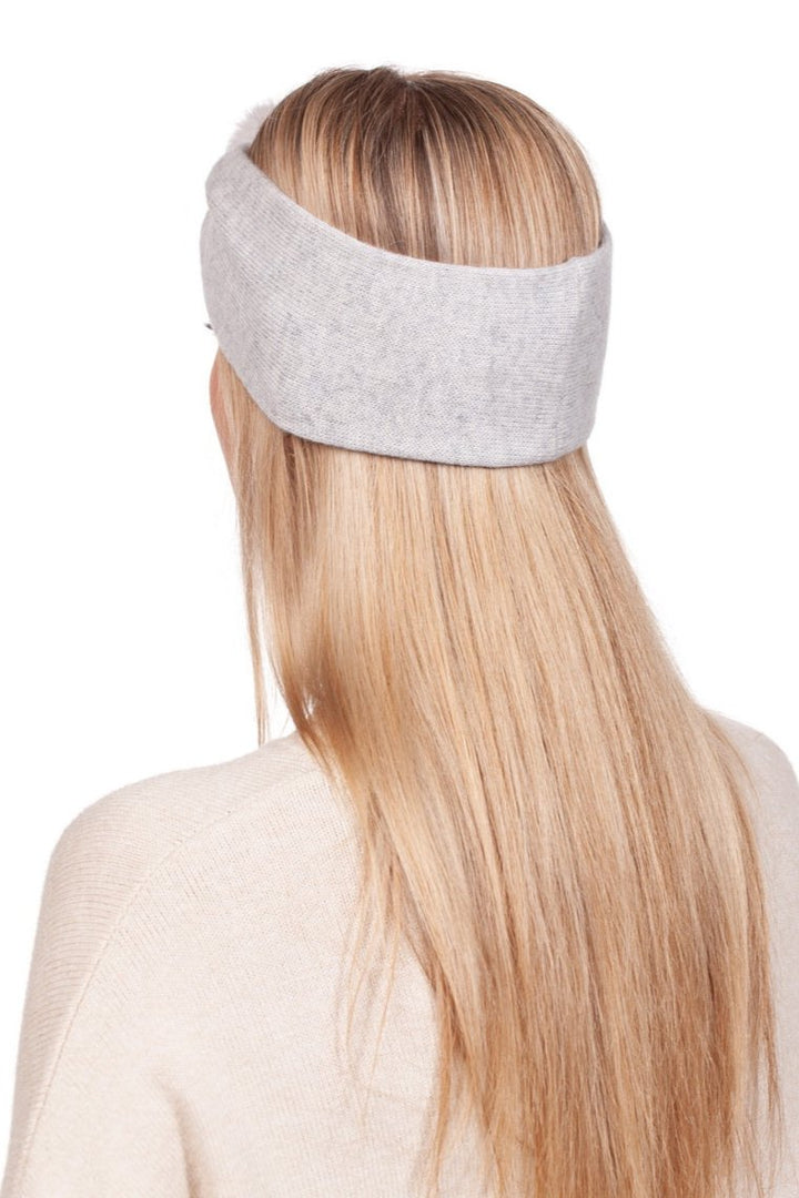 A person with long blonde hair is wearing a luxurious Light Grey Cashmere And Mink Fur Headband by FurbySD and a light cream sweater, photographed from behind.