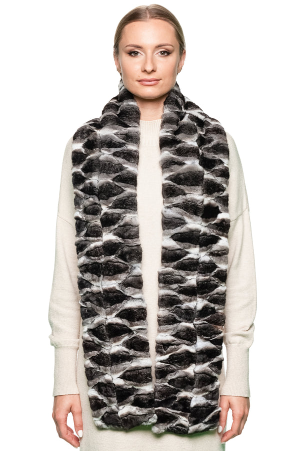 Woman wearing a patterned chinchilla fur scarf on a white background.