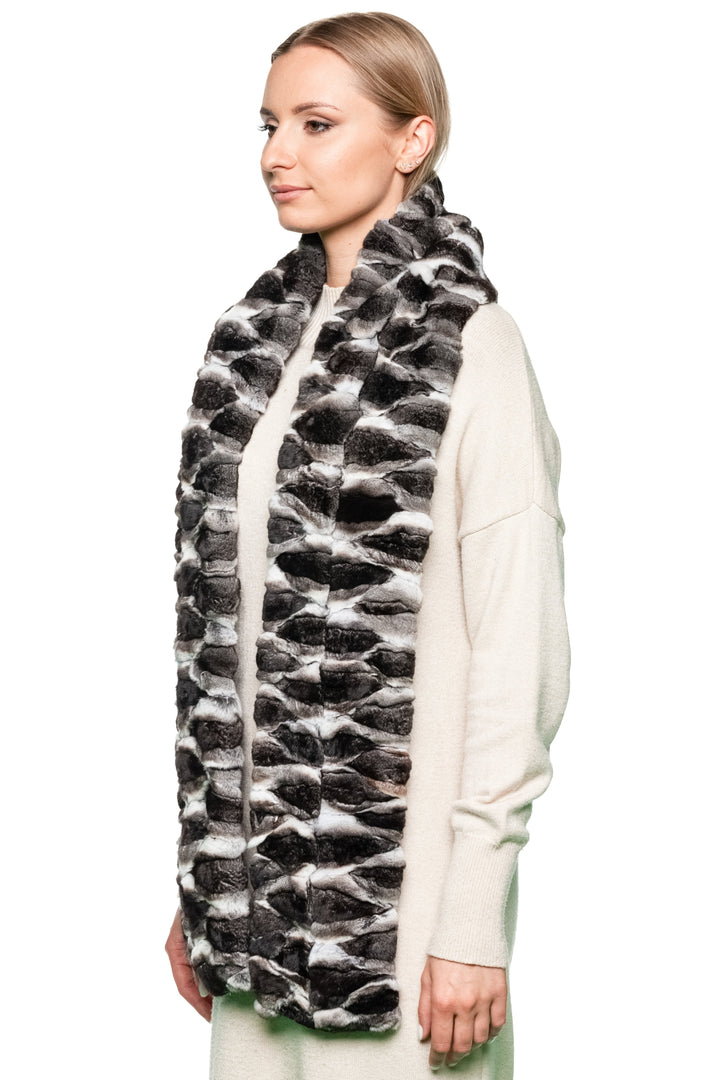 Woman wearing a natural chinchilla fur patterned scarf against a white background