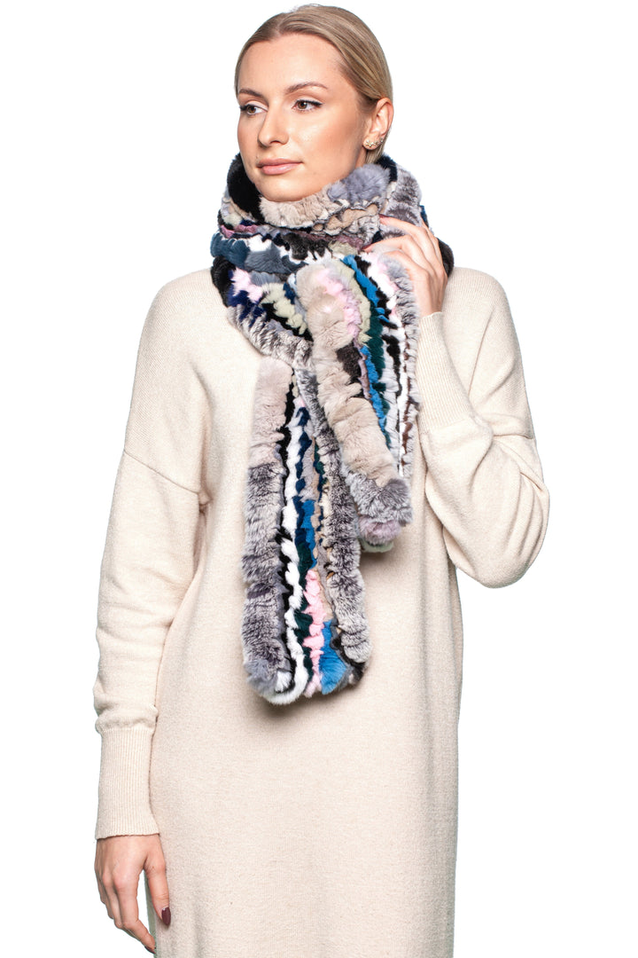 Woman wearing a stylish multicolor Rex rabbit fur knit scarf, showcasing luxury and warmth.