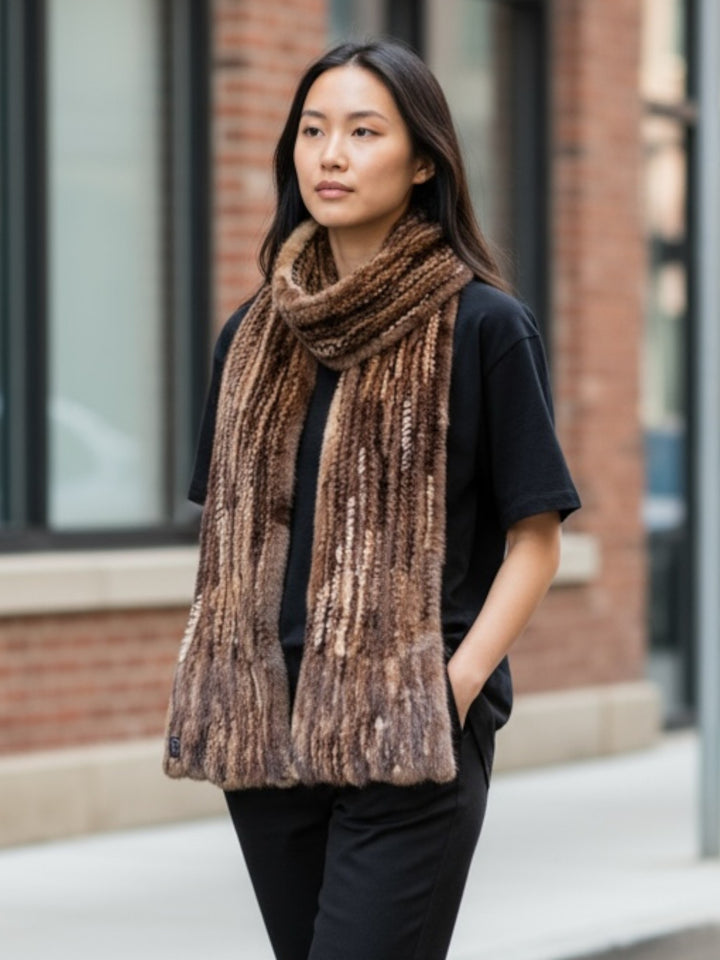Woman wearing a large brown mink fur scarf outdoors in front of a brick building.