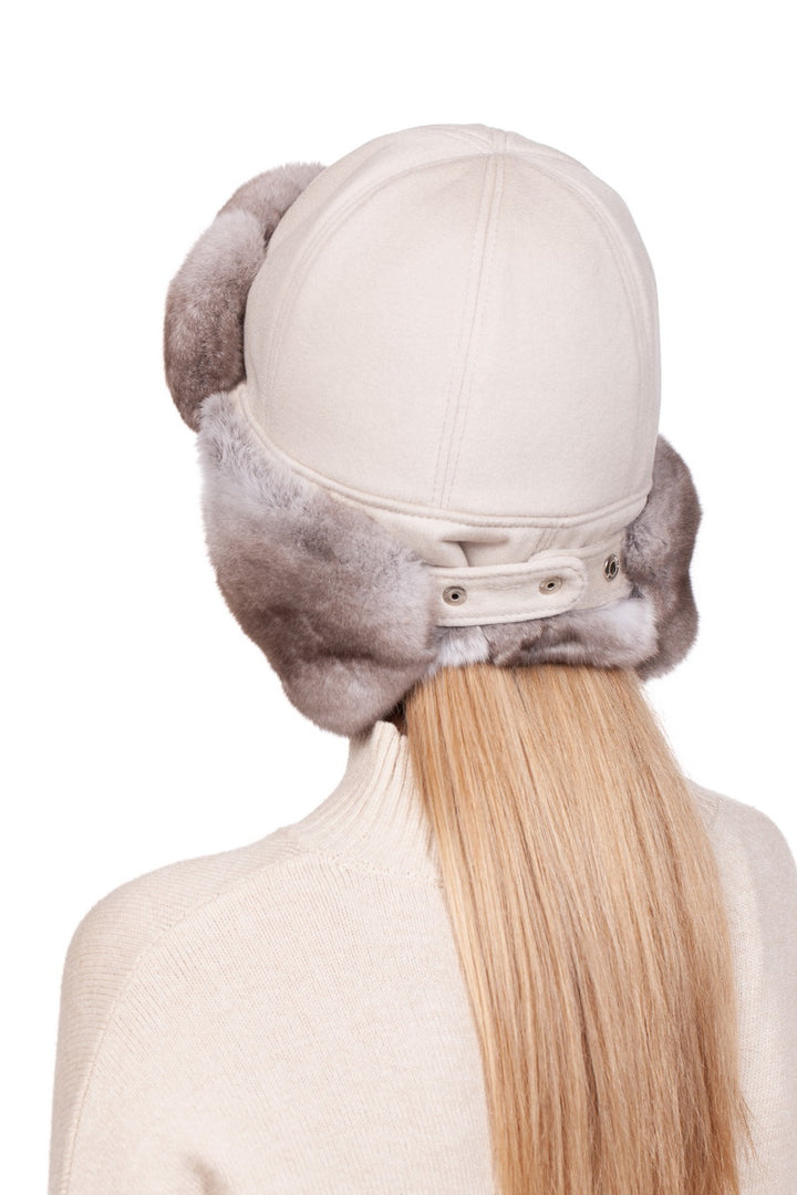 Beige chinchilla fur trapper hat featuring cream cashmere for warmth and style.