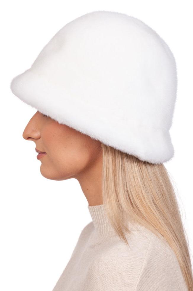 Side profile of a person with long blonde hair wearing the FurbySD White Mink Fur Bucket Hat paired with a light beige sweater against a plain white background.