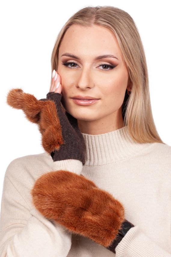 A woman with long blonde hair poses gracefully against a white background, wearing a cream sweater and Rust Brown Mink Fur Mittens by FurbySD. Her hand gently touches her face, highlighting the elegance and style of these luxurious mittens.