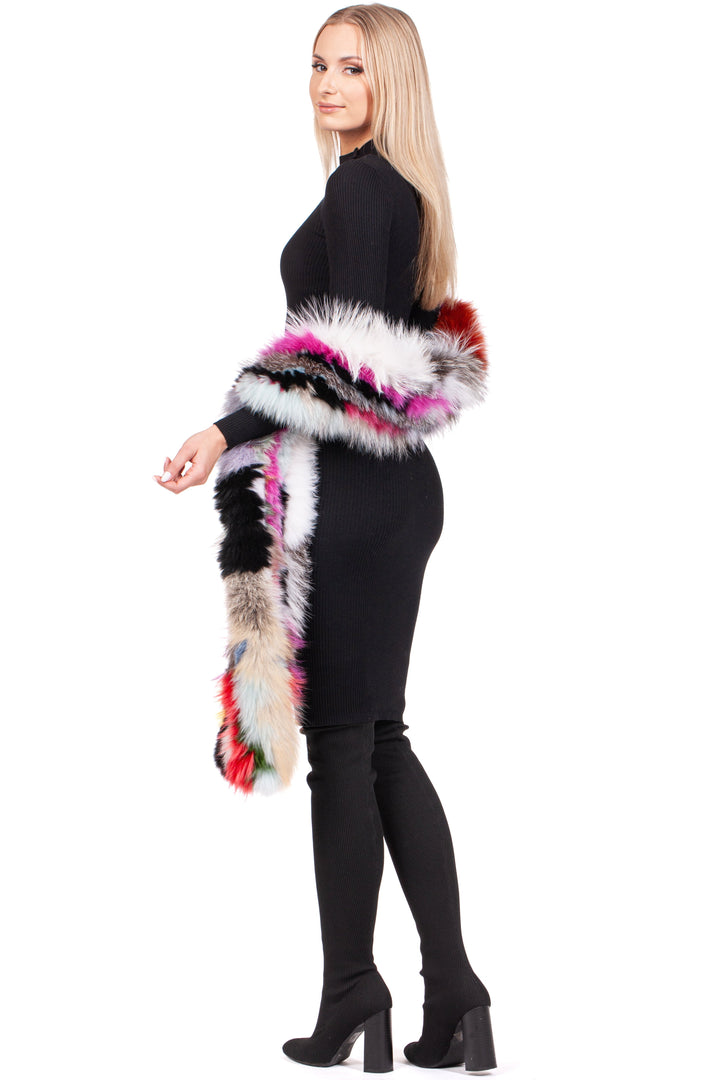 A woman in a black dress and knee-high boots poses with the luxurious FurbySD Long Knitted Fox Fur Scarf draped over her shoulder. Featuring vibrant red, pink, white, black, and blue hues against a plain white background, this multicolor accessory adds an elegant touch to her ensemble.