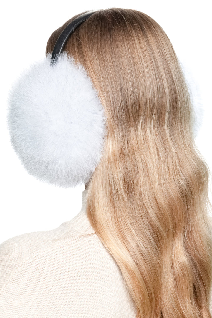 Close-up side profile of natural blue fox fur earmuffs with leather band, luxury handmade real fur ear warmers for cozy winter wear.