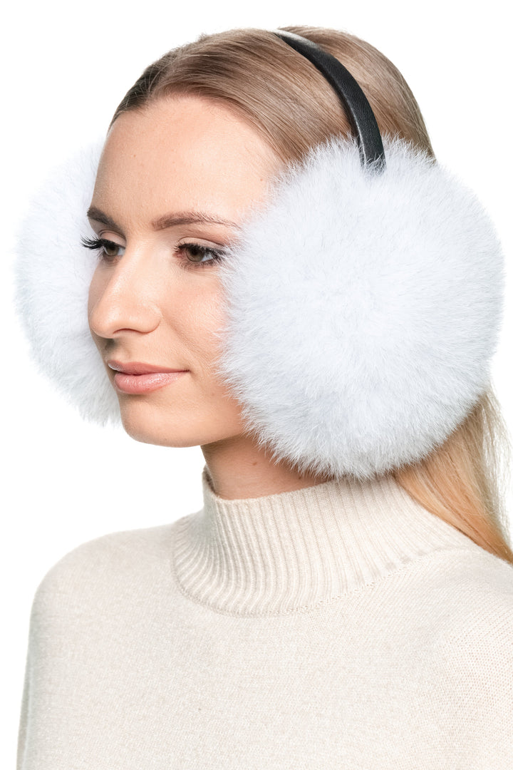 Close-up side profile of natural blue fox fur earmuffs with leather band, luxury handmade real fur ear warmers for cozy winter wear.