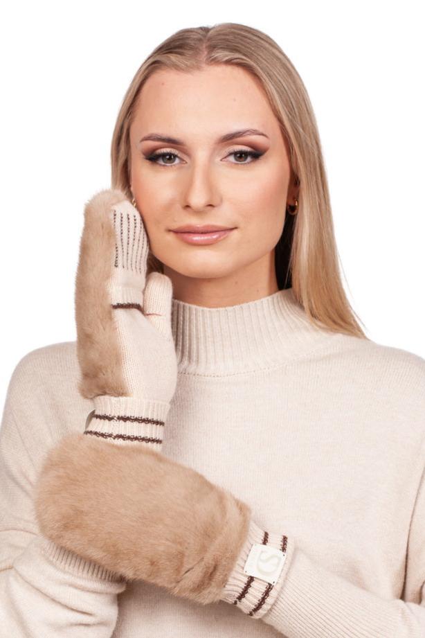 A person with long blonde hair is wearing a Beige Mink Fur Hat And Flip Top Mittens Set from FurbySD, radiating the appeal of luxury winter accessories. They pose with one hand touching their face, showcasing the mittens' label and striped detailing at the wrist.