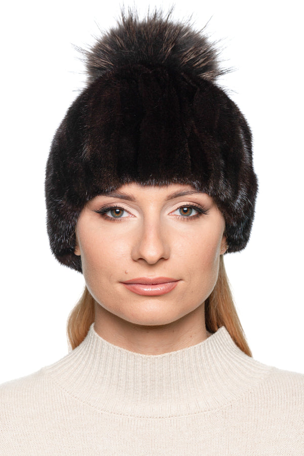 Luxury patched black and brown mink fur hat with oversized fox fur pom pom – handmade winter fashion by FurbySD, model front view.