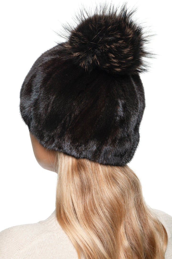 Luxury mink fur beanie with plush fox fur pom pom – black and brown patchwork winter hat by FurbySD, rear side angle.