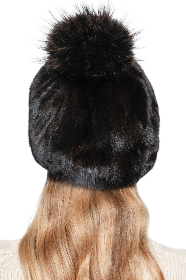 Black and brown patched mink fur hat with fluffy fox fur pom pom – handmade luxury winter hat, back view.