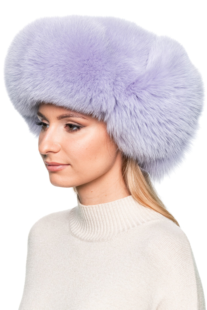 Right profile of purple fox fur trapper hat, fluffy real fur winter aviator cap with earflaps for skiing and outdoor cold weather wear.