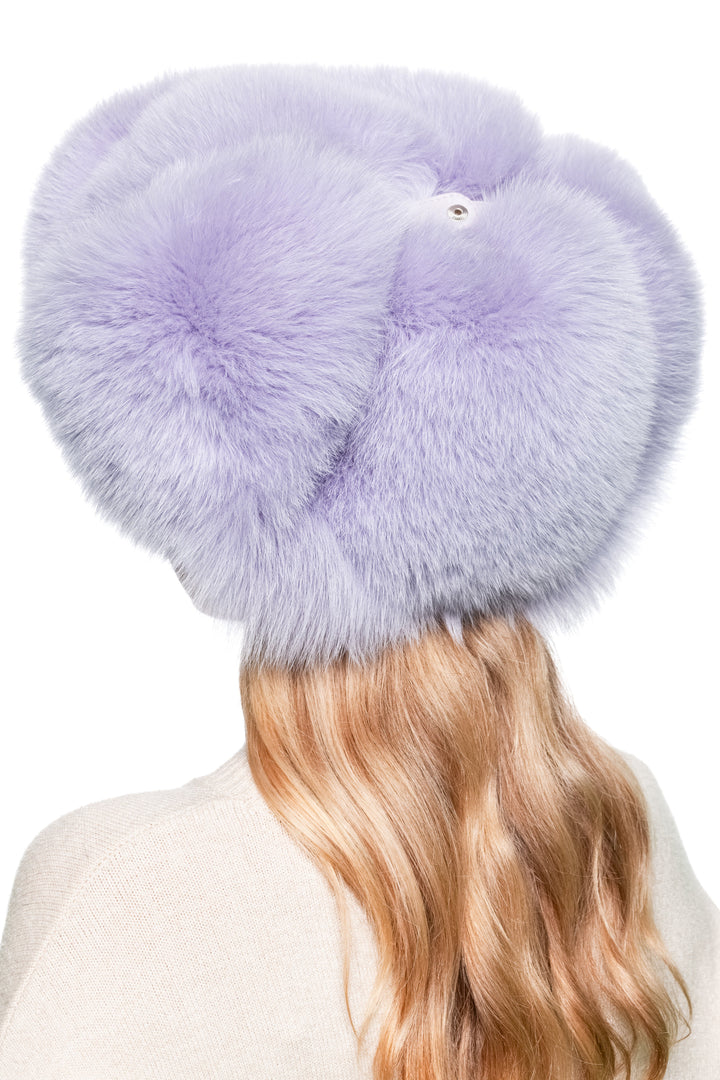 Rear angle view of purple fox fur aviator trapper hat with earflaps, voluminous fluffy real fur ski cap for men and women.