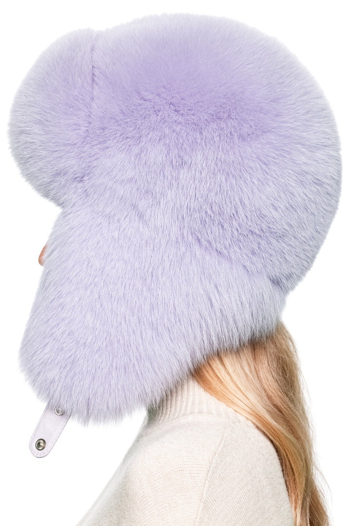 Side view of purple fox fur Russian trapper hat – oversized real fur earflap hat for skiing, luxury winter fashion, and outdoor warmth.