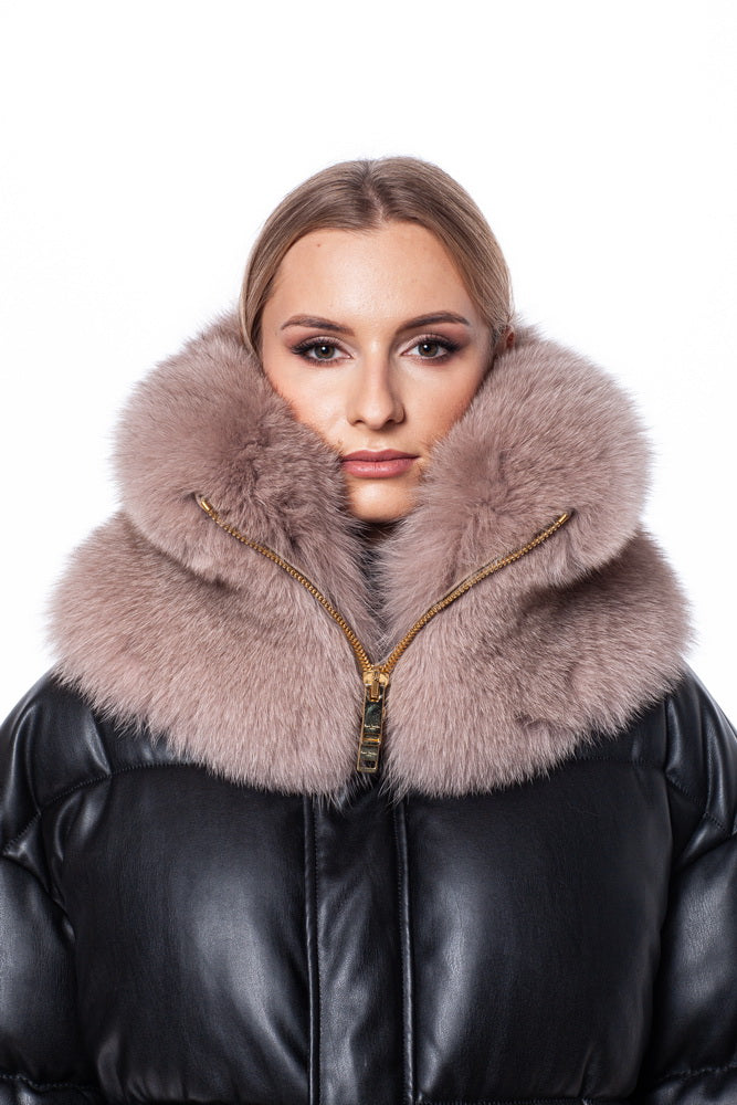 A person with blonde hair showcases the FurbySD Fox Fur Zipped Collar Scarf, a luxurious black puffer scarf adorned with an extravagant fox fur collar. The gold zipper, centrally positioned, adds a chic touch. Against the plain white background, the intricate textures of both the scarf and fur are accentuated, making this unisex winter accessory stand out even more.