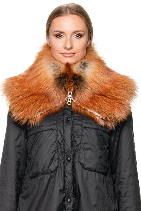 Woman wearing long black coat with red fox fur collar scarf with zipper, luxury winter outfit inspiration.