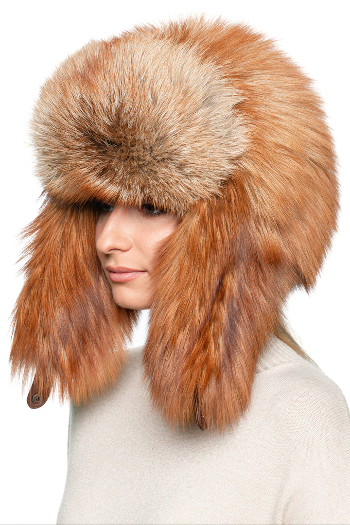 Side profile of red fox fur ushanka trapper hat with oversized earflaps, handmade Russian winter hat for men and women.