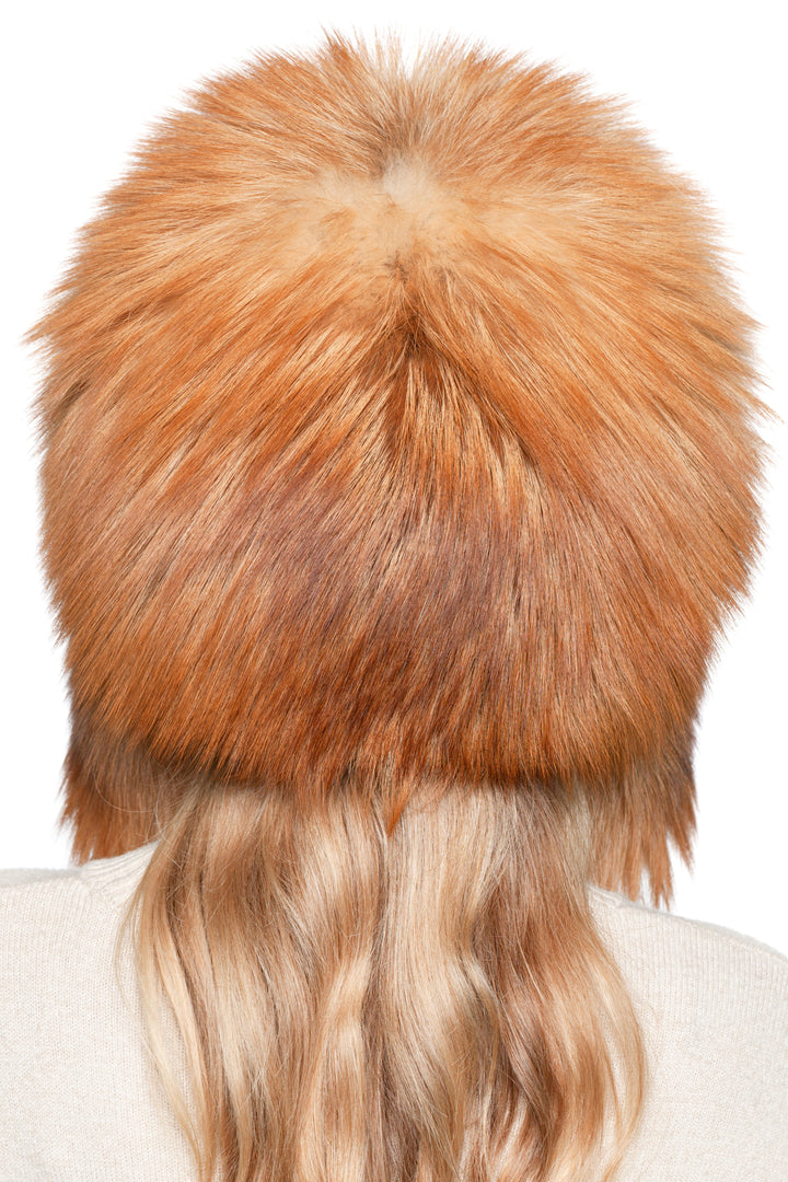 Close-up back detail of red fox fur winter hat, authentic real fur ushanka with thick fluffy crown and warm insulation.