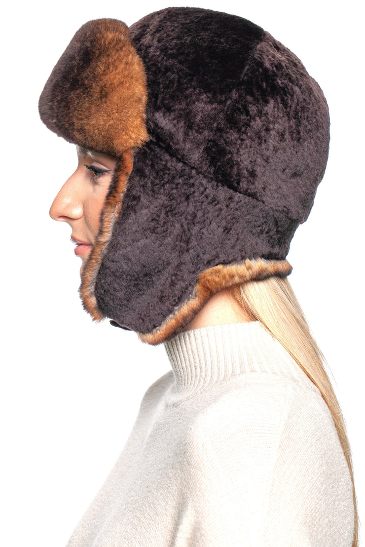 Side view of a woman wearing a luxurious brown lamb and rex rabbit fur trapper hat for winter style.