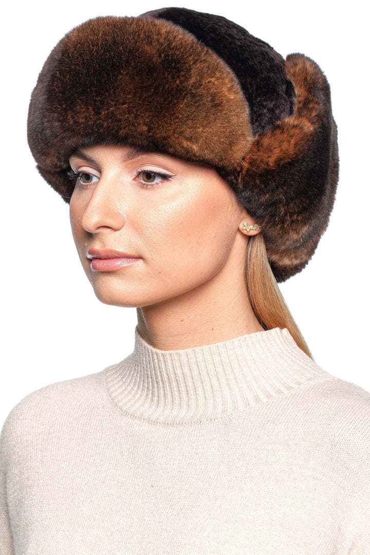 Woman wearing a luxurious brown lamb and rex rabbit fur trapper hat for winter warmth and style.