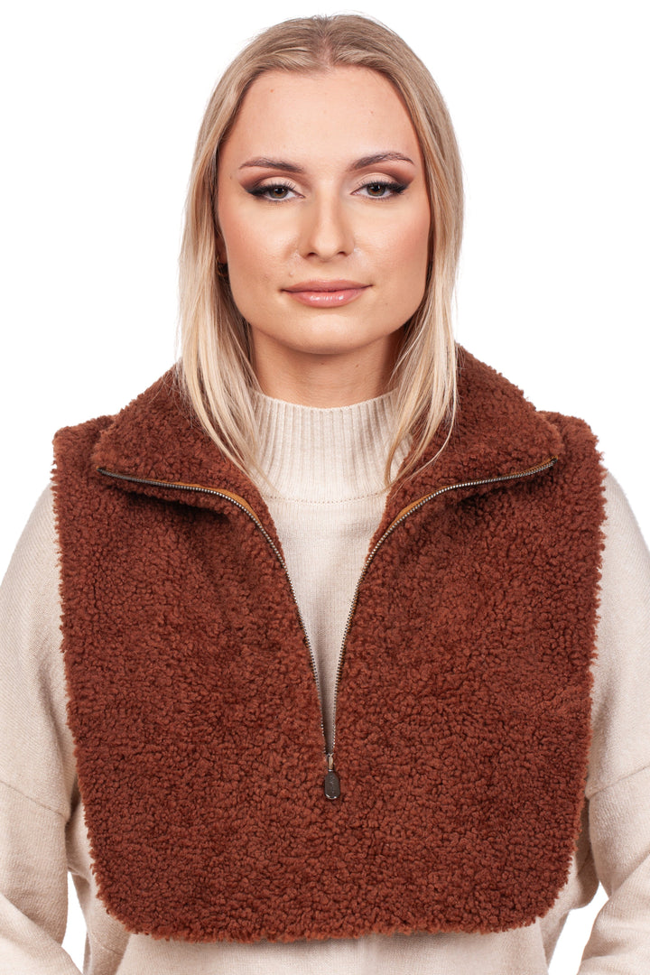 A woman with blonde hair models a Brown Shearling Fur Turtleneck Collar from FurbySD over a light beige sweater. She gazes directly at the camera, set against a plain white background.