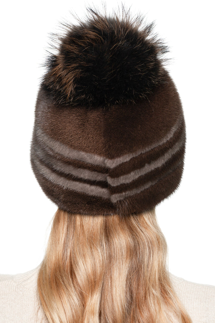 Back view of striped brown mink fur hat with voluminous fox fur pom pom, handmade real fur winter hat for women, chic and warm luxury beanie style.