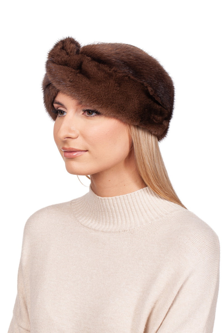 A person with long blonde hair is wearing a Brown Mink Fur Headband by FurbySD and a beige sweater. The pristine background is white.