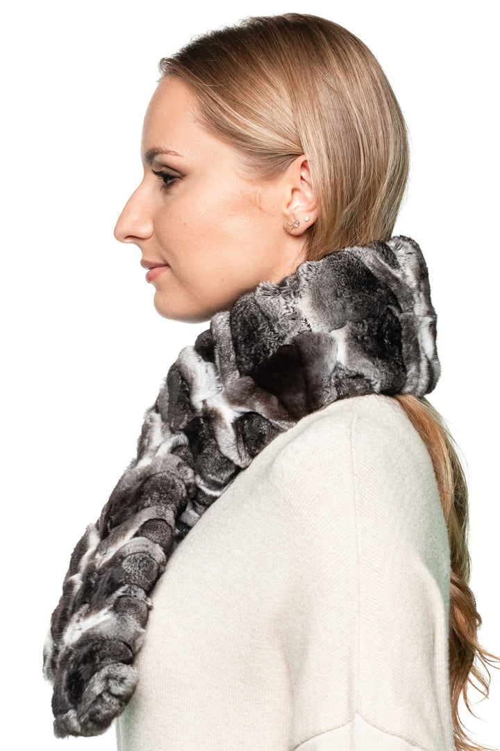 Close-up of genuine chinchilla fur scarf with plush striped texture, unisex winter accessory offering warmth, softness, and timeless elegance.