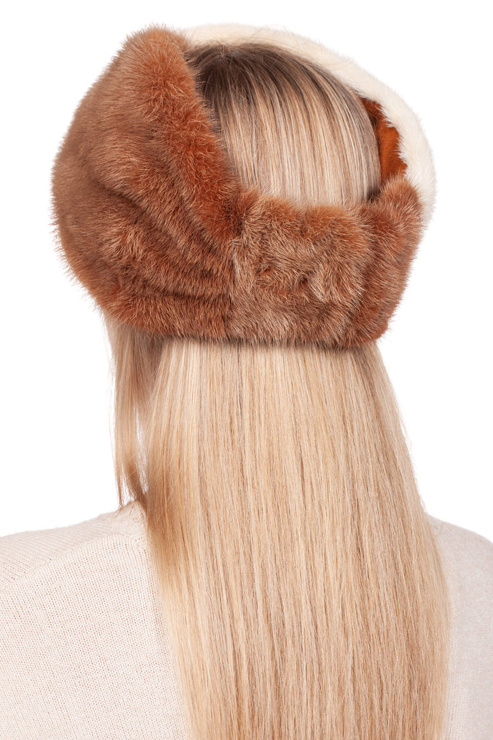 A person with long blonde hair is wearing a fluffy Two-Tone Beige Mink Fur Headband from FurbySD. The view from the back shows it wrapped around their head, above a light-colored sweater, epitomizing a luxury winter accessory.