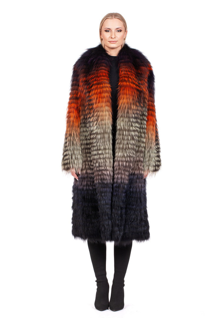 Dressed in an Ultralight Fox Fur Coat by FurbySD, featuring a vibrant blend of orange, red, gray, and black hues, the individual stands against a white backdrop. They complement the luxurious fur jacket with black pants and have light-colored hair styled back.